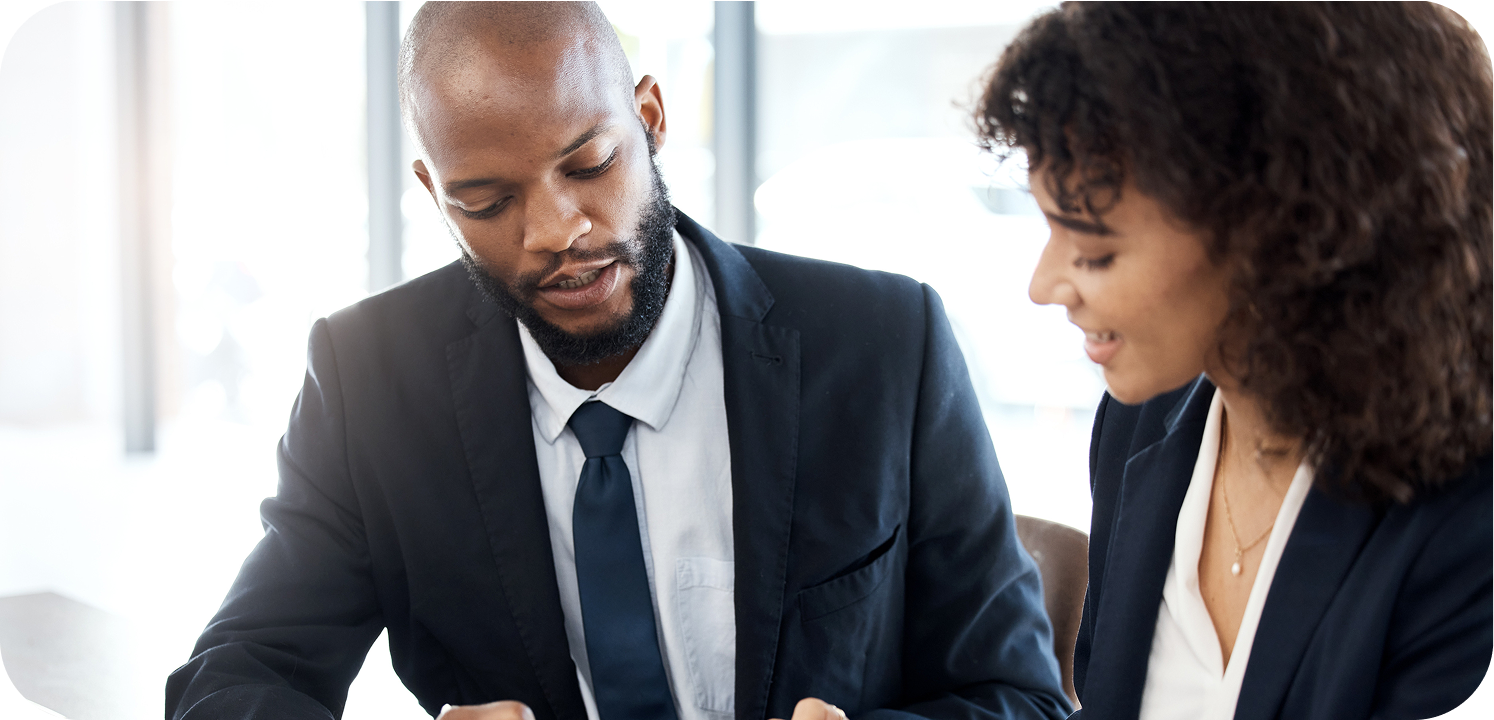 Two legal professionals reviewing documents at a desk
